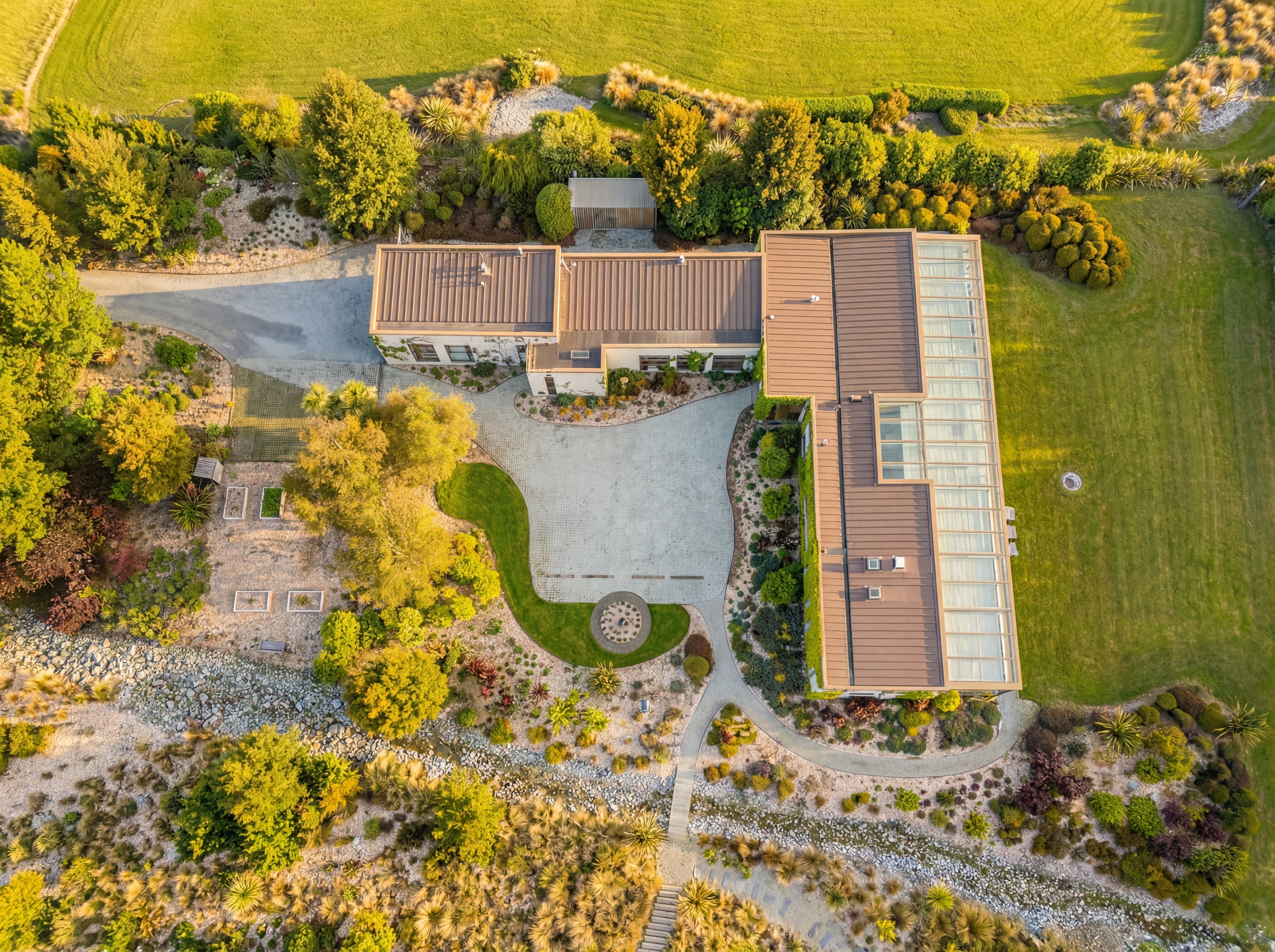 Aerial view showing the full building footprint, conservatory, turning circle and landscaped grounds